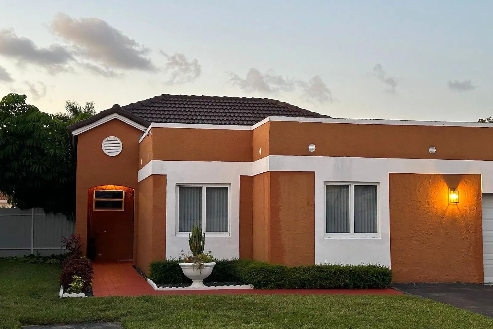 A tile roof before and after being cleaned and painted — after
