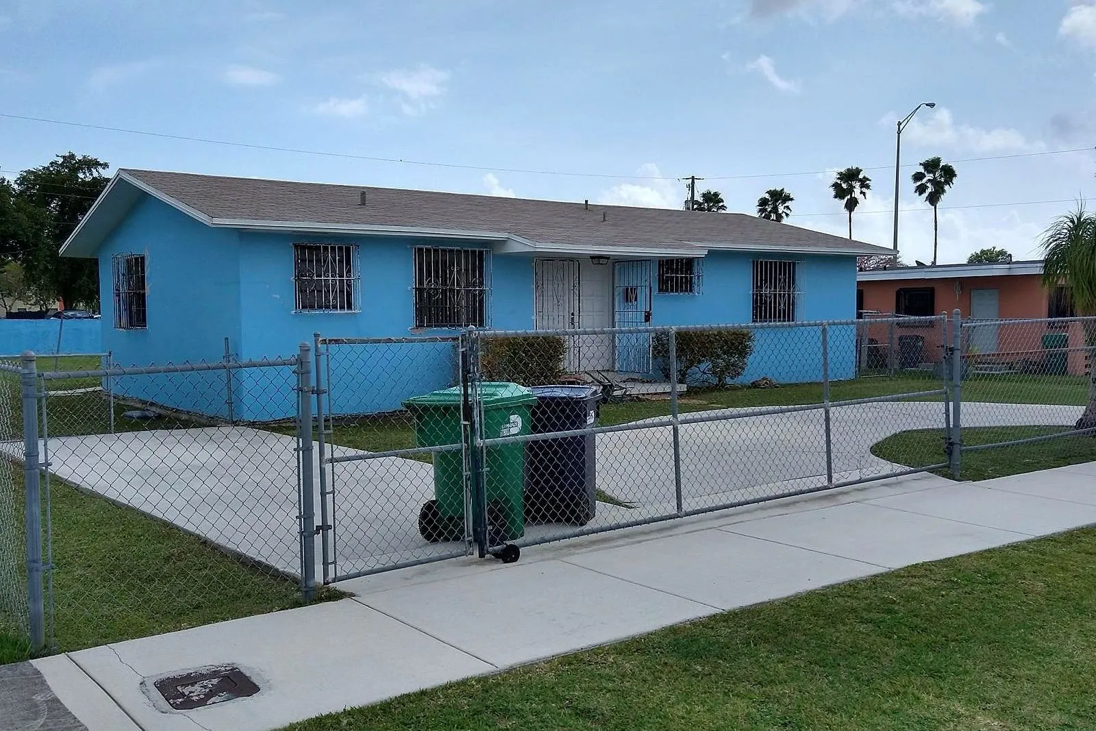 A driveway, apron and public sidewalk grey with dirt before cleaning, and clean after — after