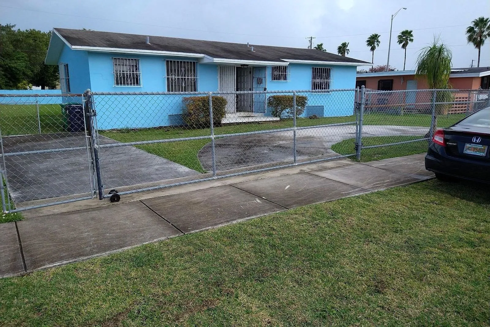 A driveway, apron and public sidewalk grey with dirt before cleaning, and clean after — before