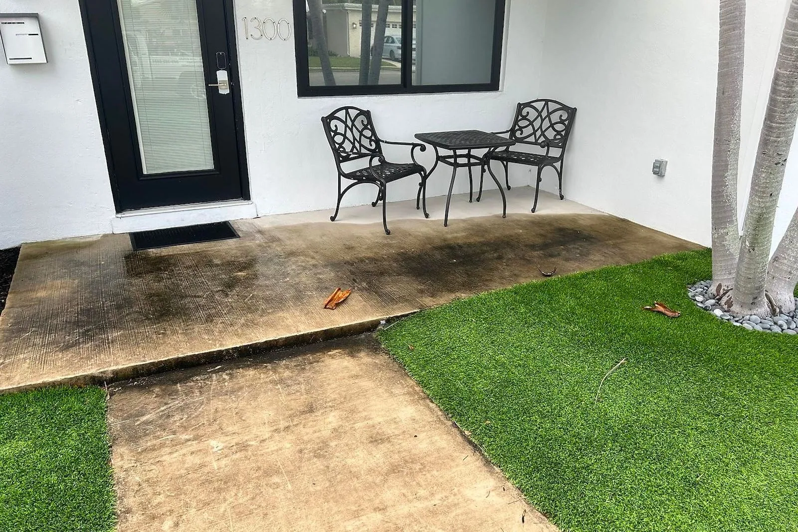 A front porch and walkway before and after cleaning — before