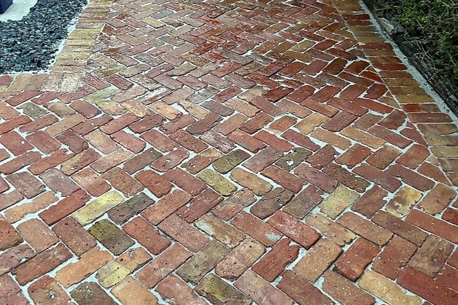 A brick paver walkway before and after cleaning — after