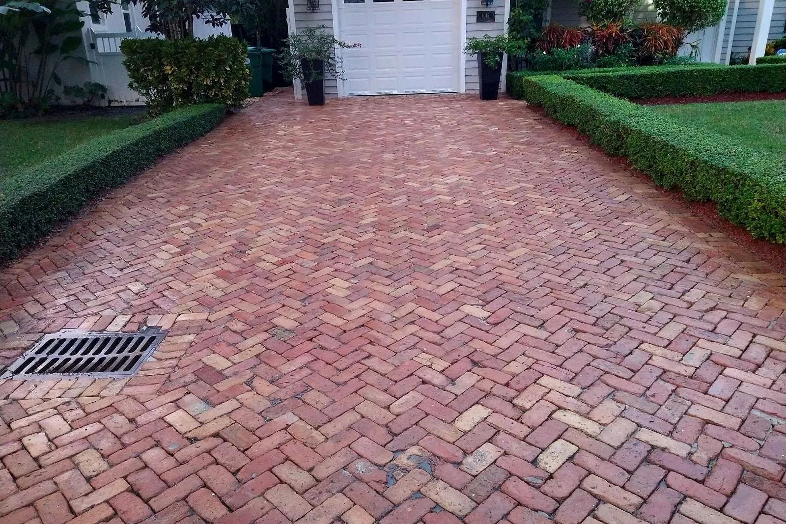 The same brick paver driveway after cleaning, back to a deep red