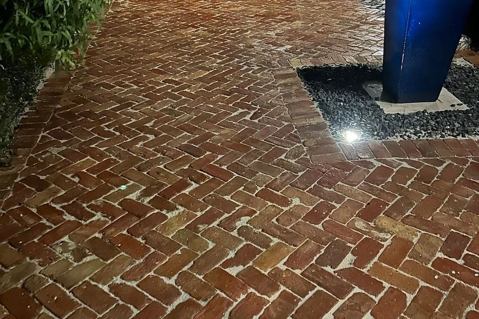 A brick paver courtyard before and after cleaning, re-sanding and sealing — after