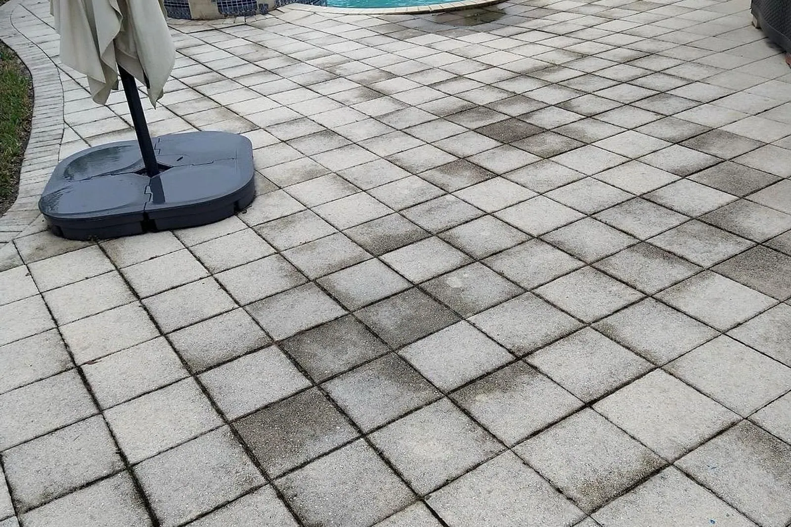 A tiled pool deck before and after cleaning, with the pool and spa in frame — before