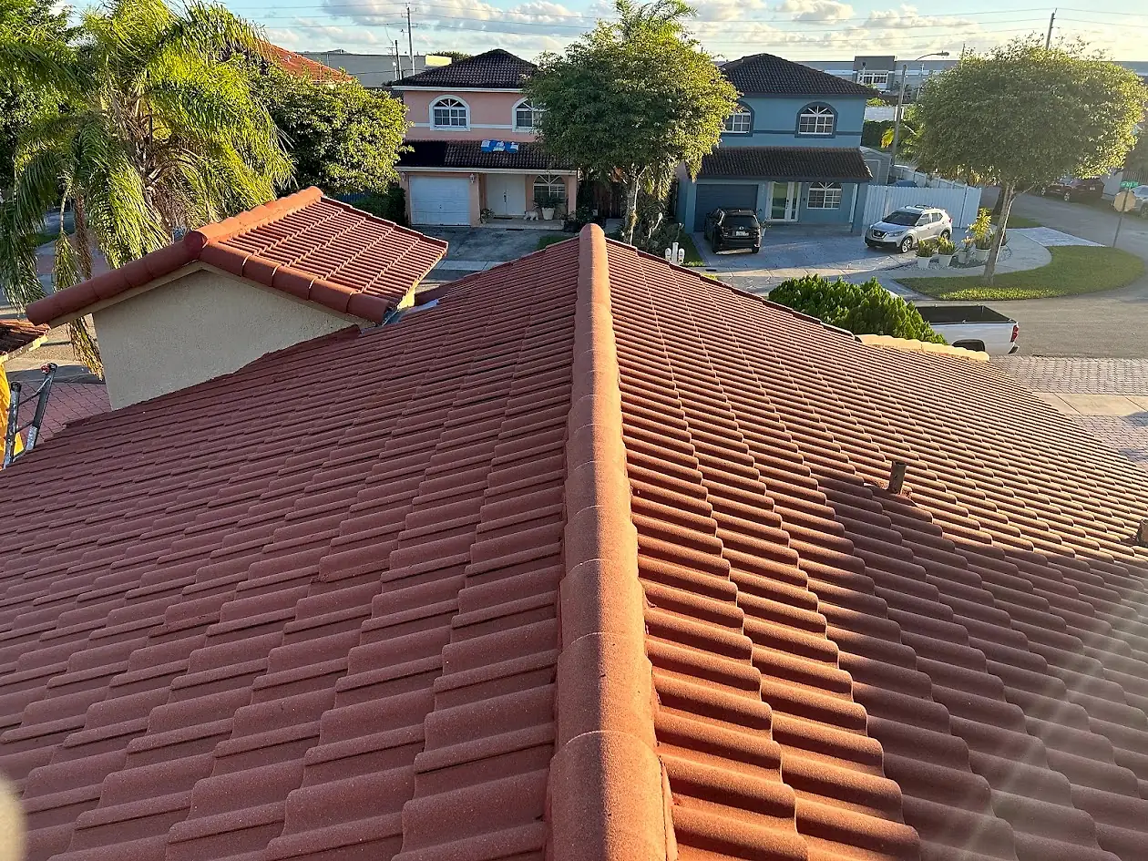 A freshly cleaned terracotta barrel tile roof in Fort Lauderdale, with the neighborhood behind it